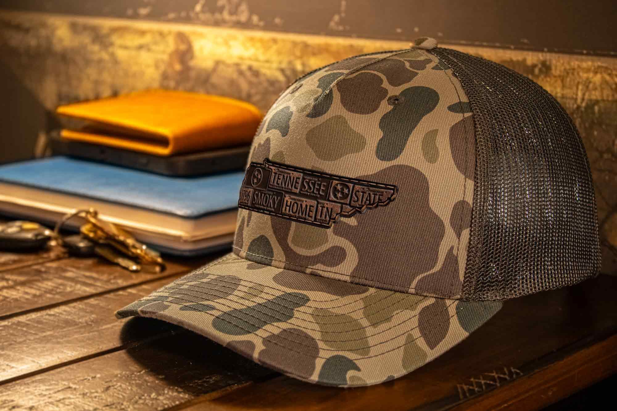 Tennessee Map Old School Camo Trucker Hat. Burnished Full Grain Leather Patch. 5-Panel Richardson 112 Snapback Cap. Stitched Map Patch.