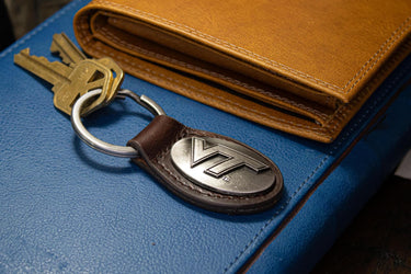Virginia Tech Hokies Oval Leather Key Fob. Split Ring and Durable Stitching. Perfect Collegiate Key Chain Gift. Brown or Black Leather.
