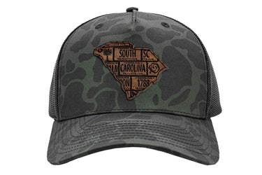 South Carolina Map Old School Camo Trucker Hat. Burnished Full Grain Leather Patch. 5-Panel Richardson 112 Snapback Cap. Stitched Map Patch.