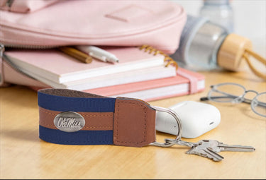 Ole Miss Rebels Collegiate Grosgrain Ribbon Key Chain with Leather Accent and Silver Emblem.