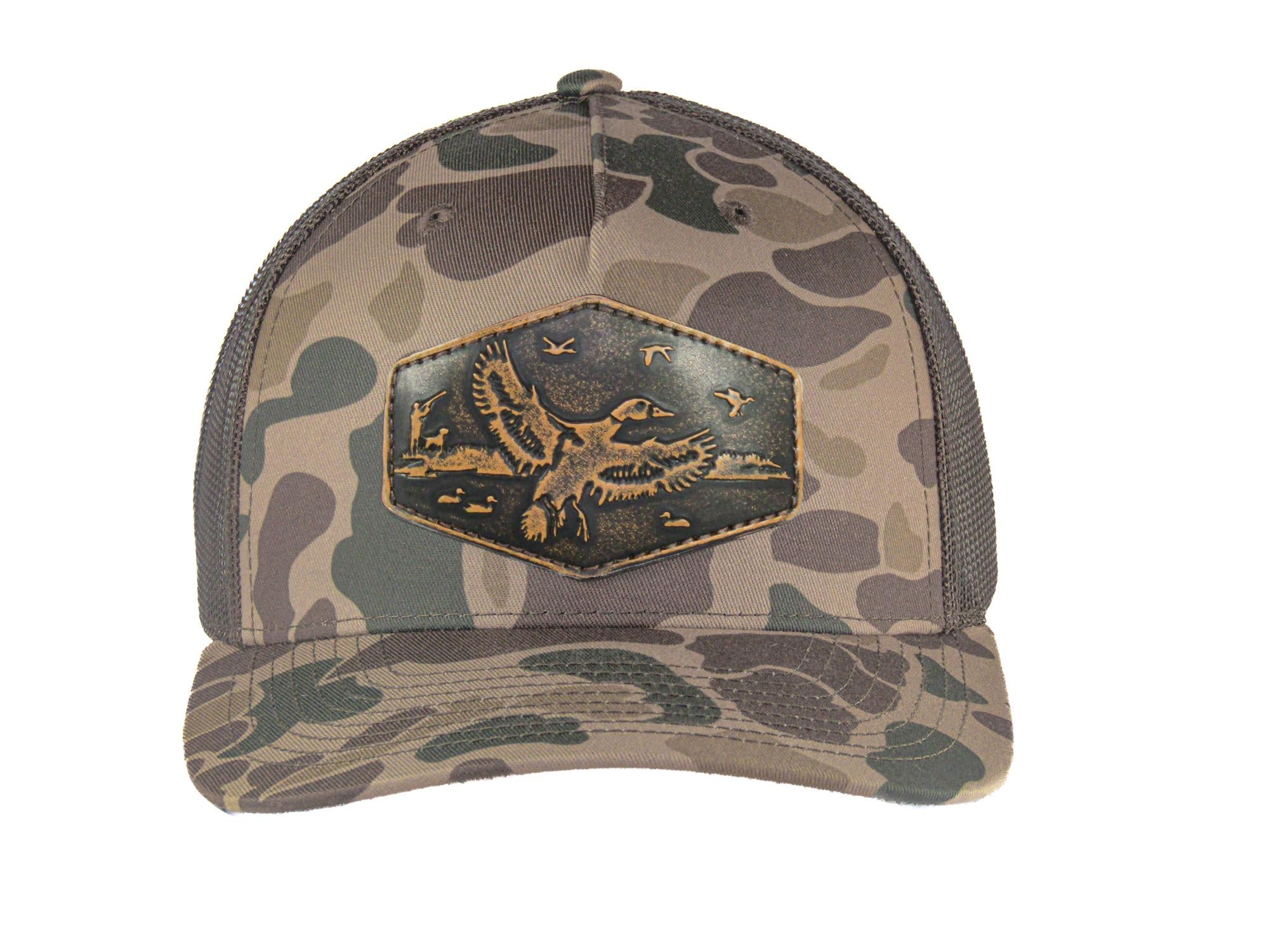 Mallard Old School Camo Trucker Hat. Hand Burnished Full Grain Leather Patch. 5-Panel Richardson 112 Snapback Cap. Stitched Duck Patch.