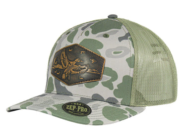 Mallard Old School Camo Trucker Hat. Hand Burnished Full Grain Leather Patch. 5-Panel Richardson 112 Snapback Cap. Stitched Duck Patch.