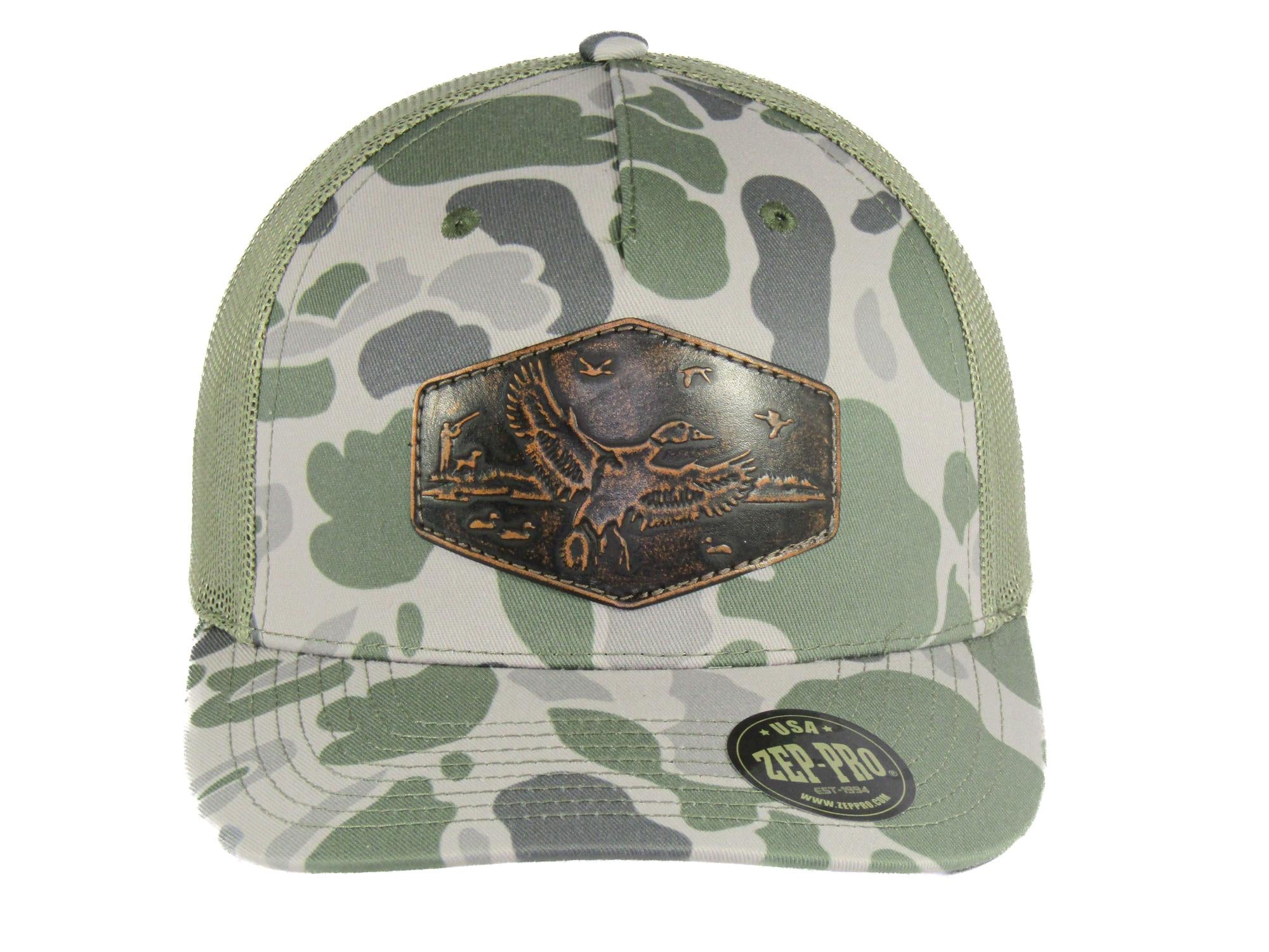 Mallard Old School Camo Trucker Hat. Hand Burnished Full Grain Leather Patch. 5-Panel Richardson 112 Snapback Cap. Stitched Duck Patch.