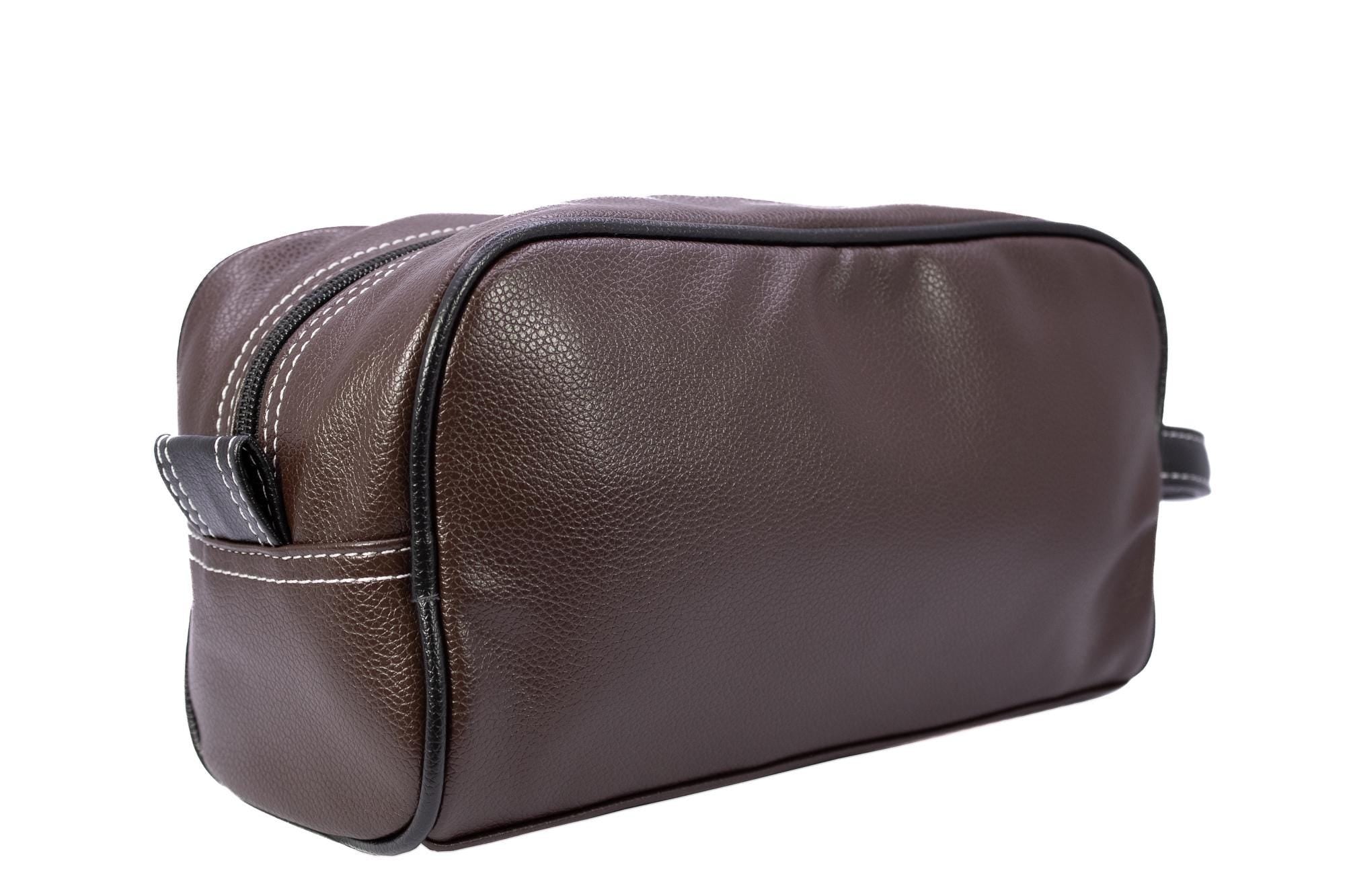 Auburn Tigers Men's Toiletry Dopp Bag. Brown Pebble PU Finish. Auburn Silver Logo. Durable Water Resistant. Compact and Spacious Design.