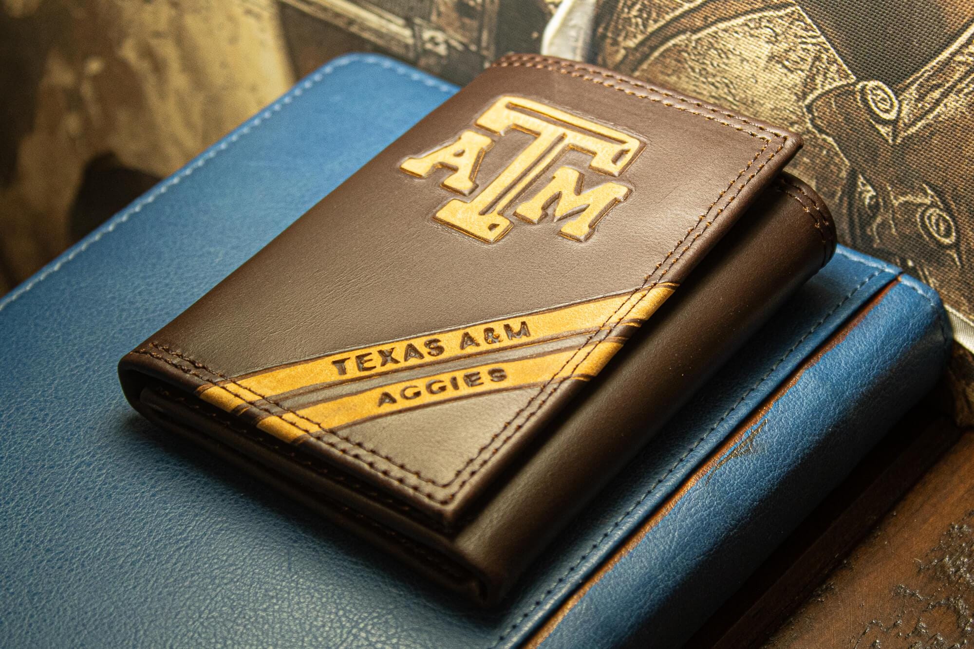 Texas A&M Aggies Men's Embossed Leather Wallet. Texas Trifold. Texas AM Secretary. Brown Collegiate Wallet. Aggies Athletic Print.