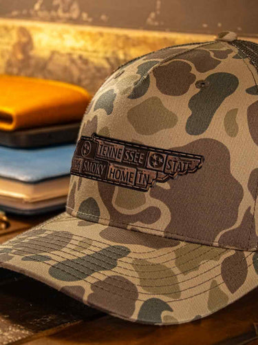 Tennessee Map Old School Camo Trucker Hat. Burnished Full Grain Leather Patch. 5-Panel Richardson 112 Snapback Cap. Stitched Map Patch.