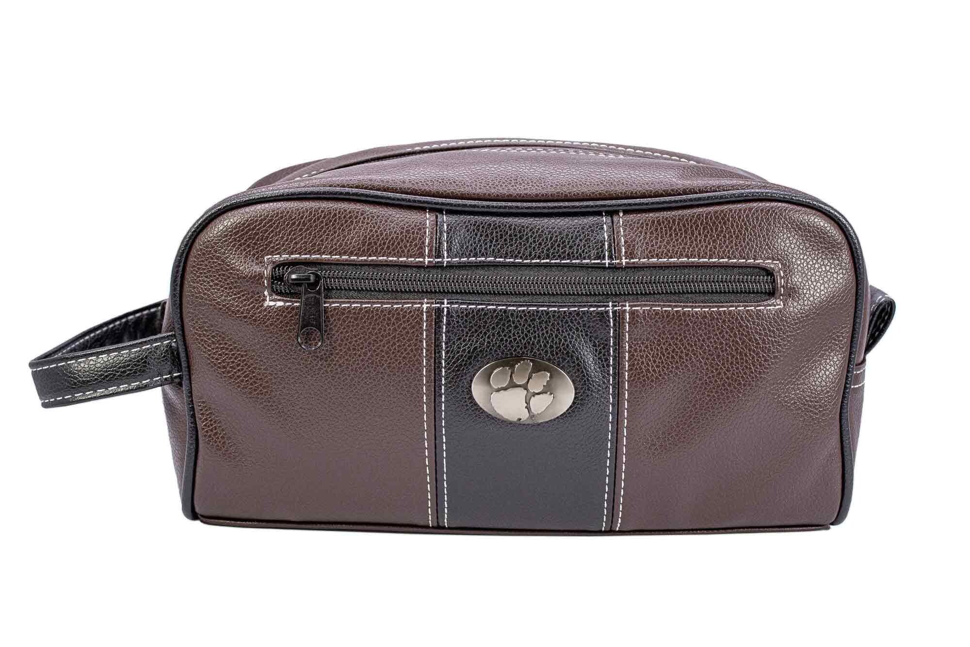 Clemson Tigers Men's Toiletry Dopp Bag. Brown Pebble PU Finish. Clemson Silver Logo. Durable Water Resistant. Compact and Spacious Design.
