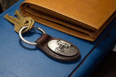 Texas Tech Red Raiders Oval Leather Key Fob. Split Ring and Durable Stitching. Perfect Collegiate Key Chain Gift. Brown or Black Leather.