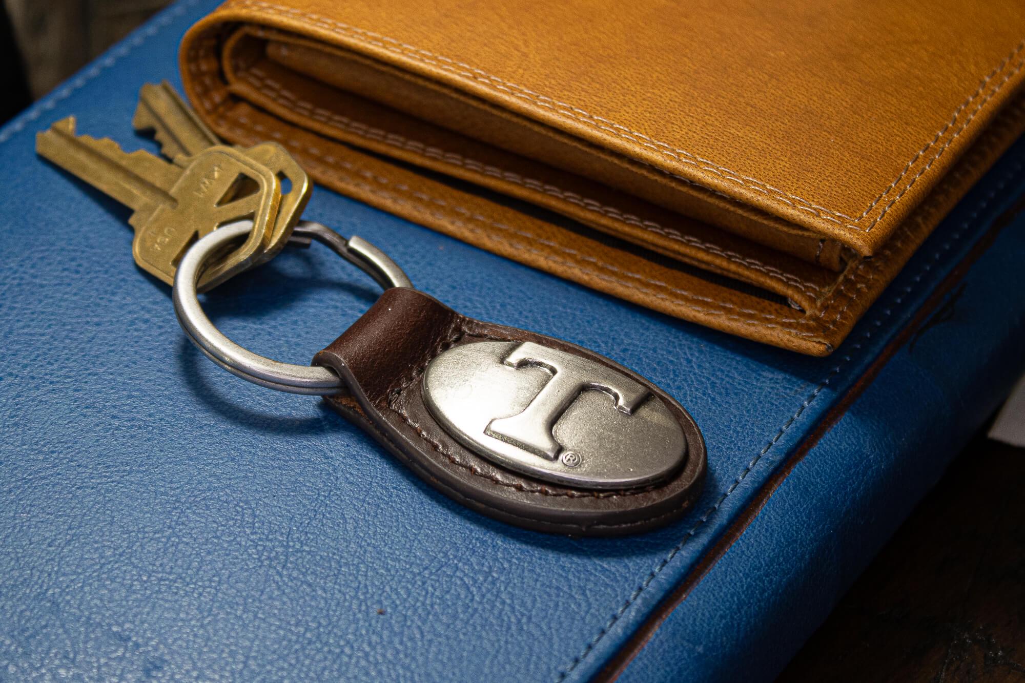 Tennessee Vols Oval Leather Key Fob. Sturdy Split Ring and Durable Stitching. Perfect Collegiate Key Chain Gift. Brown or Black Leather.