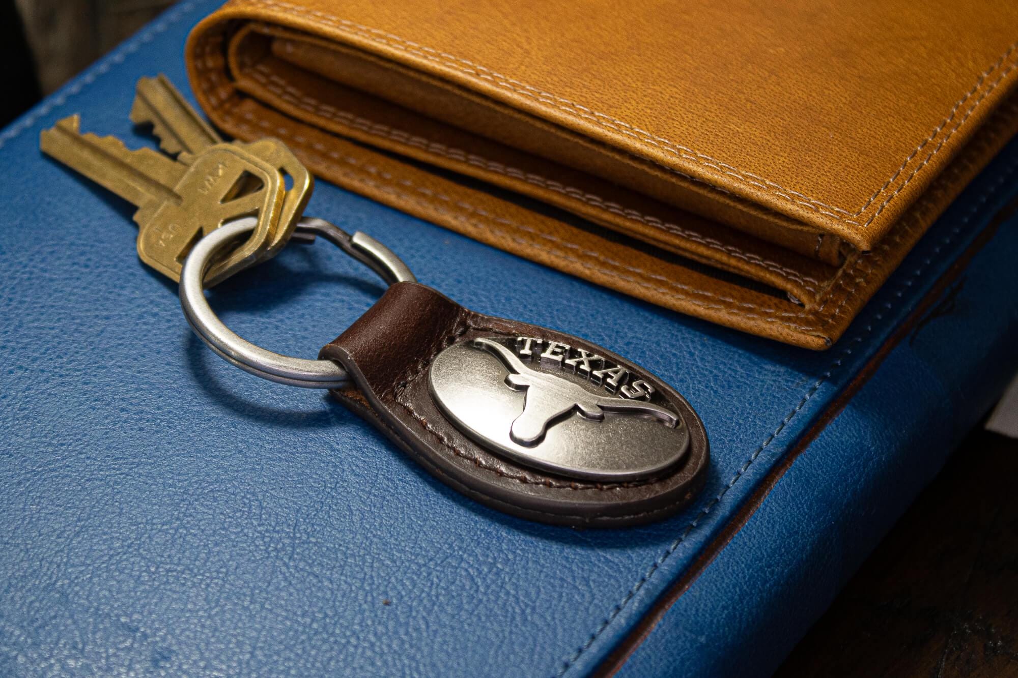 Texas Longhorns Oval Leather Key Fob. Sturdy Split Ring and Durable Stitching. Perfect Collegiate Key Chain Gift. Brown or Black Leather.