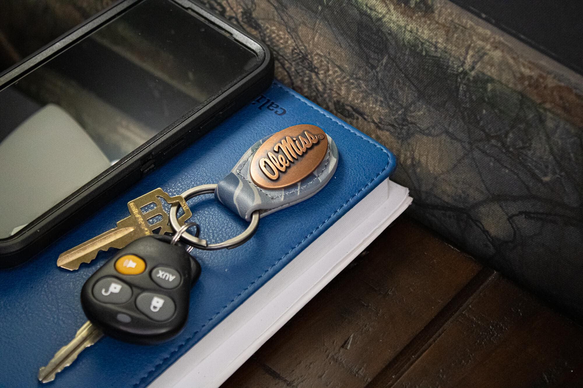 Ole Miss Rebels Oval Camo Leather Key Fob. Split Ring and Durable Stitching. Perfect Collegiate Key Chain Gift. Old School Camo Key Chain.