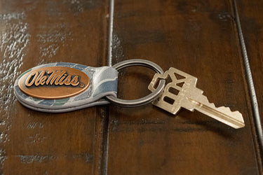 Ole Miss Rebels Oval Camo Leather Key Fob. Split Ring and Durable Stitching. Perfect Collegiate Key Chain Gift. Old School Camo Key Chain.