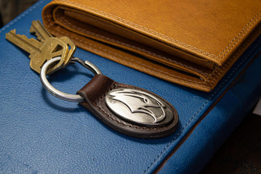 Southern Miss Eagles Oval Leather Key Fob. Split Ring and Durable Stitching. Perfect Collegiate Key Chain Gift. Brown or Black Leather.