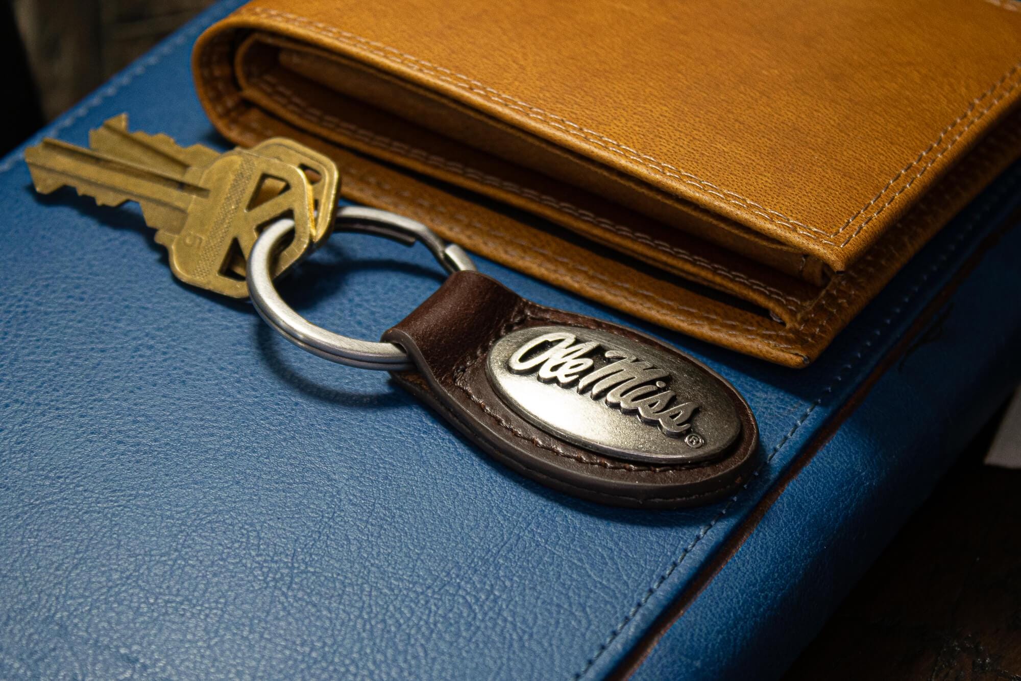 Ole Miss Rebels Oval Leather Key Fob. Sturdy Split Ring and Durable Stitching. Perfect Collegiate Key Chain Gift. Brown or Black Leather.
