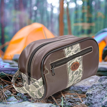 Ole Miss Rebels Men's Camo Dopp Kit. Toiletry Bag. Old School Camo Print. Brown Pebble Finish. Antique Copper Logo. Perfect Travel Accessory