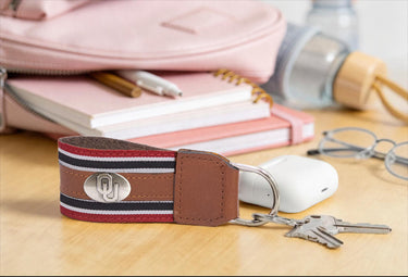 Oklahoma Sooners Collegiate Grosgrain Ribbon Key Chain with Leather Accent and Silver Emblem.