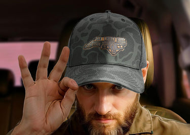 North Carolina Map Old School Camo Trucker Hat. Burnished Full Grain Leather Patch. 5-Panel Richardson 112 Snapback Cap. Stitched Map Patch.